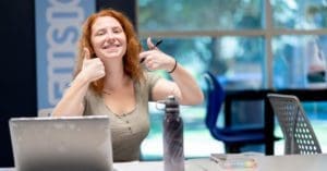 Reading Day: student giving a thumbs up while studying