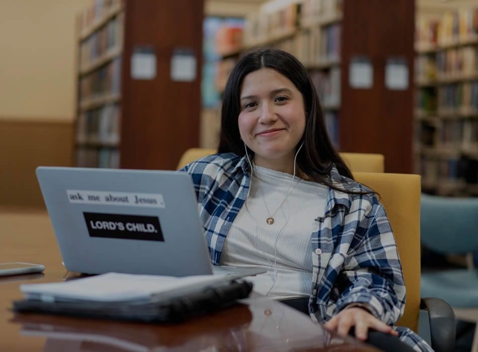 First Time Students - student studying in the library on laptop